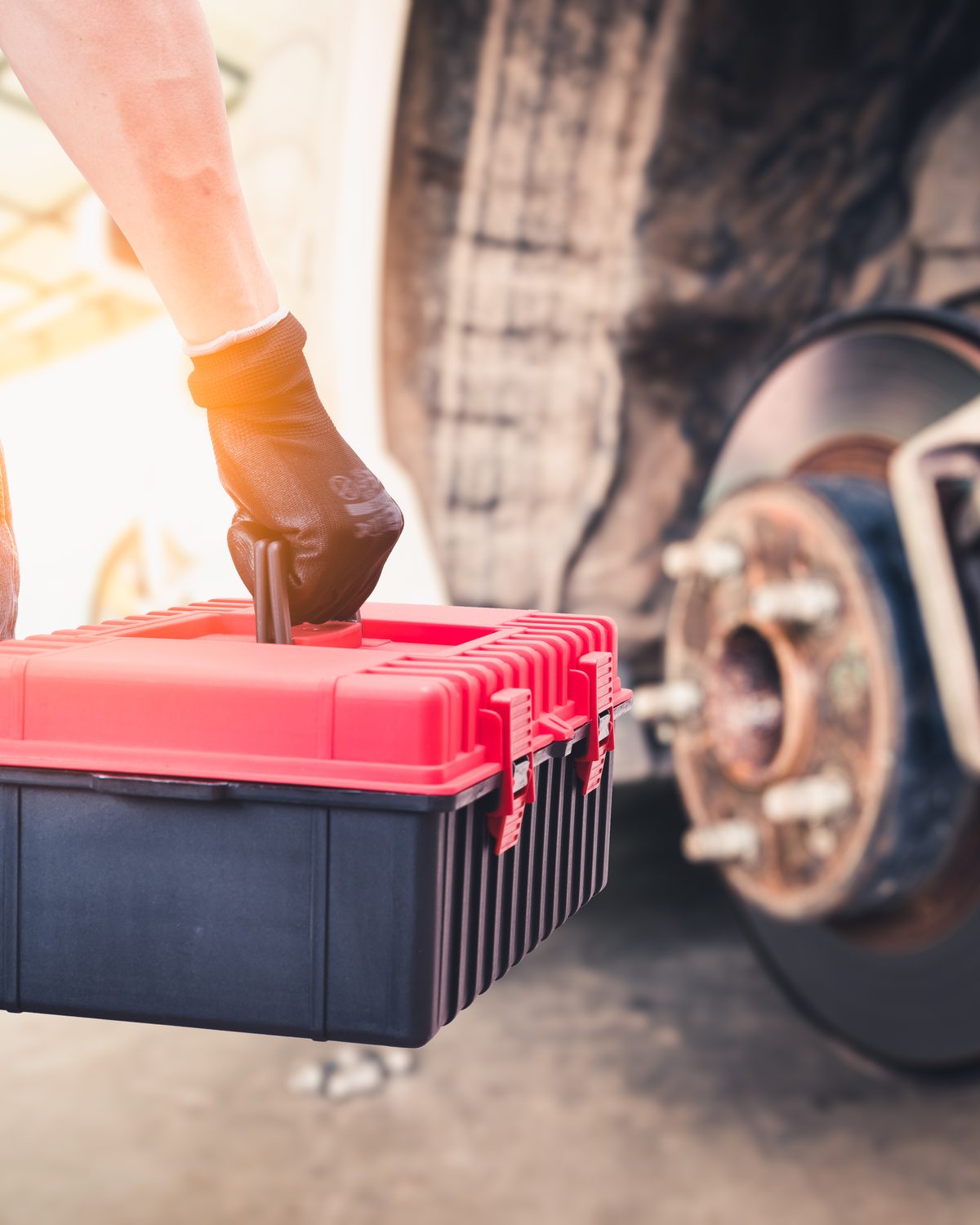 Mobile mechanic working on a vehicle on-site